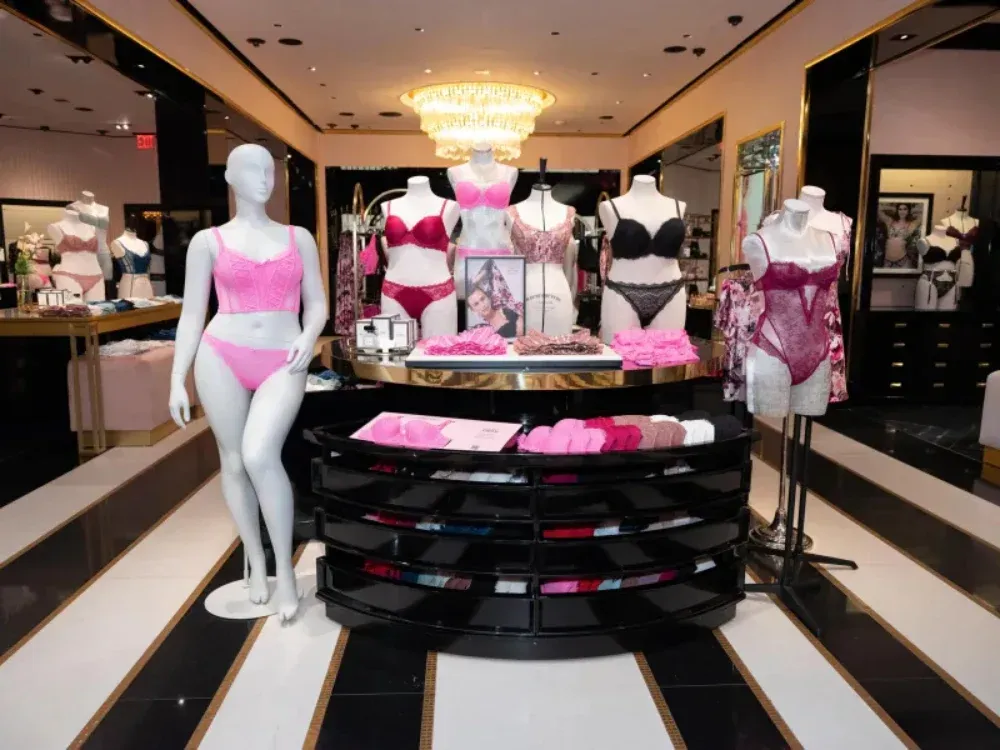 A display of pink lingerie in a store with mannequins