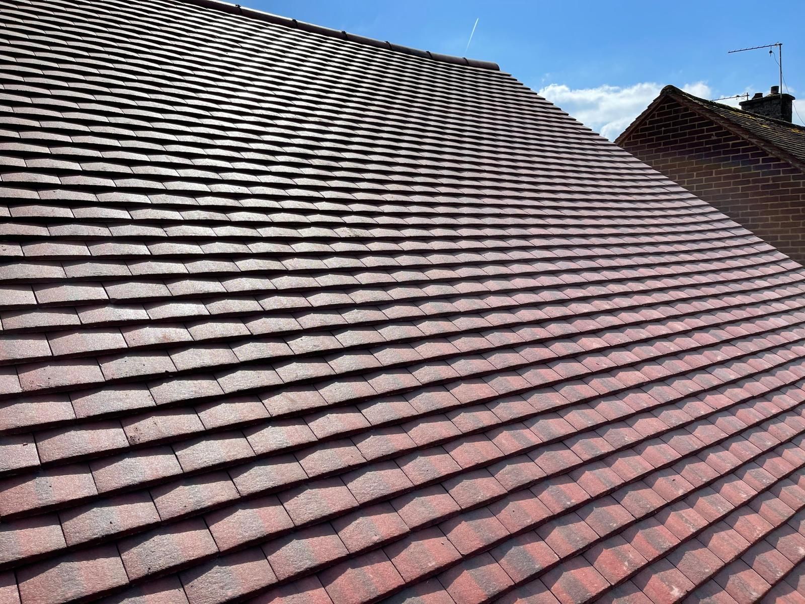 a red tiled roof with a blue sky in the background