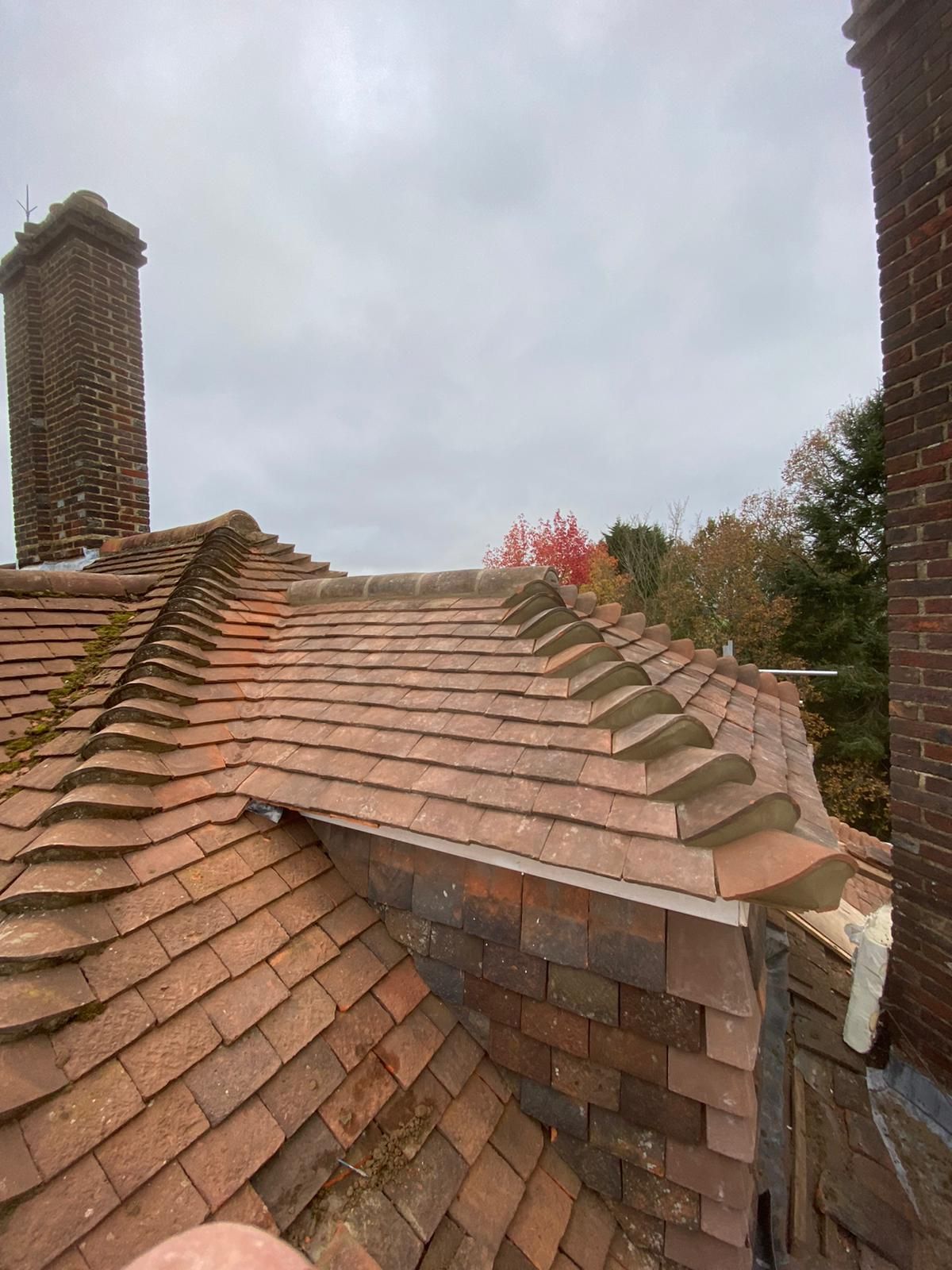 A brick roof with a chimney on top of it.