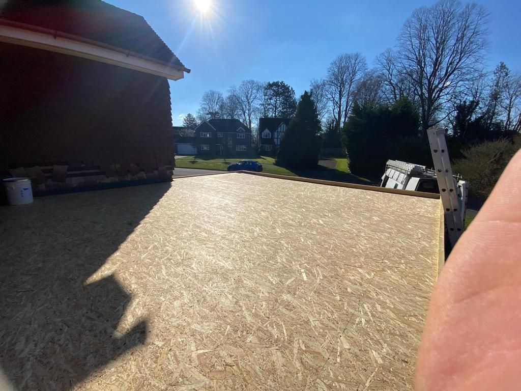 a large piece of plywood is sitting in front of a house