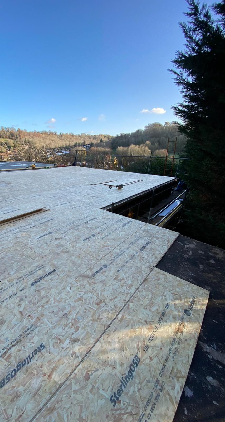 a stack of sterlingss plywood sits on a roof