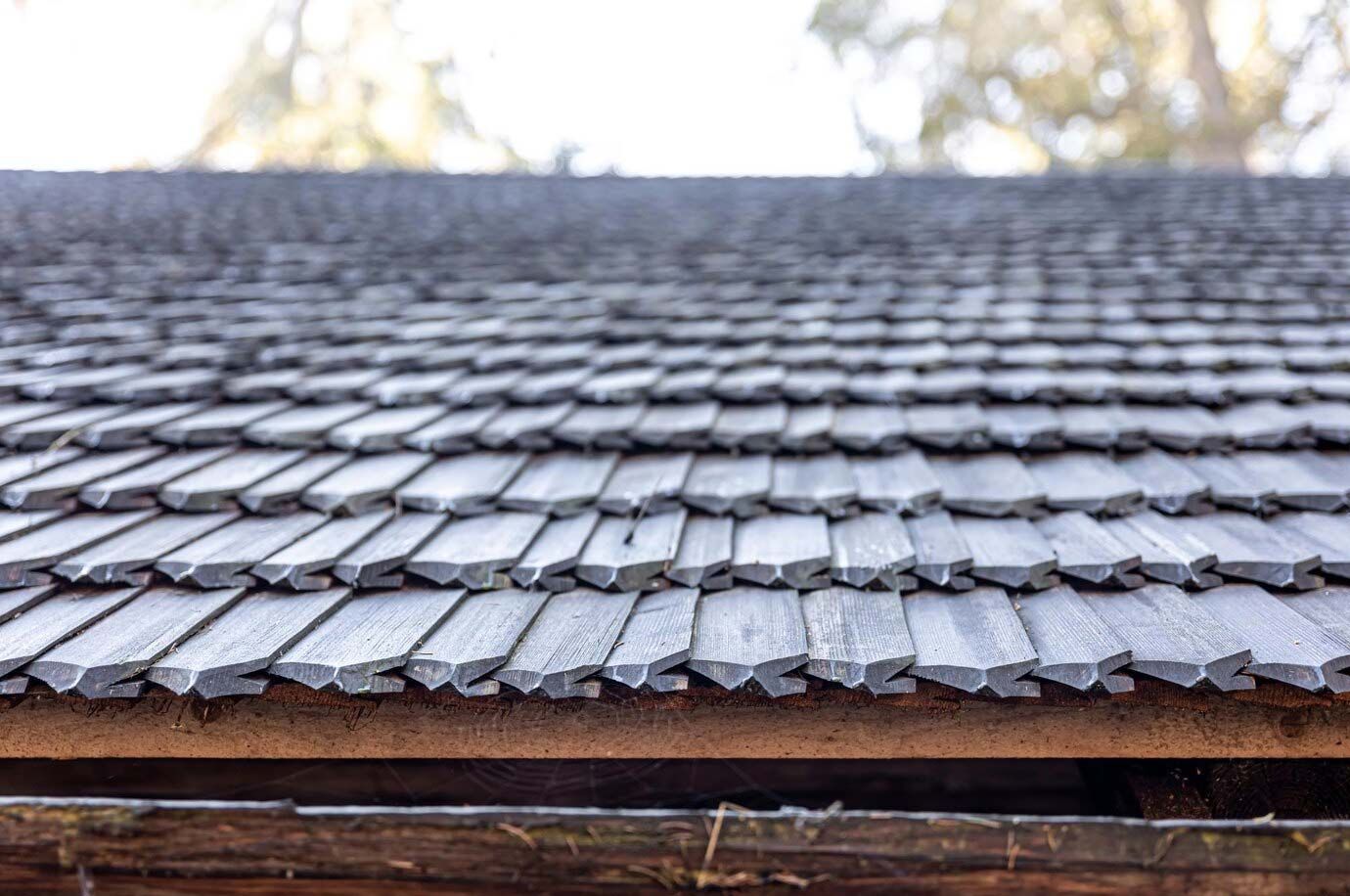 A close up of a wooden roof with shingles on it.