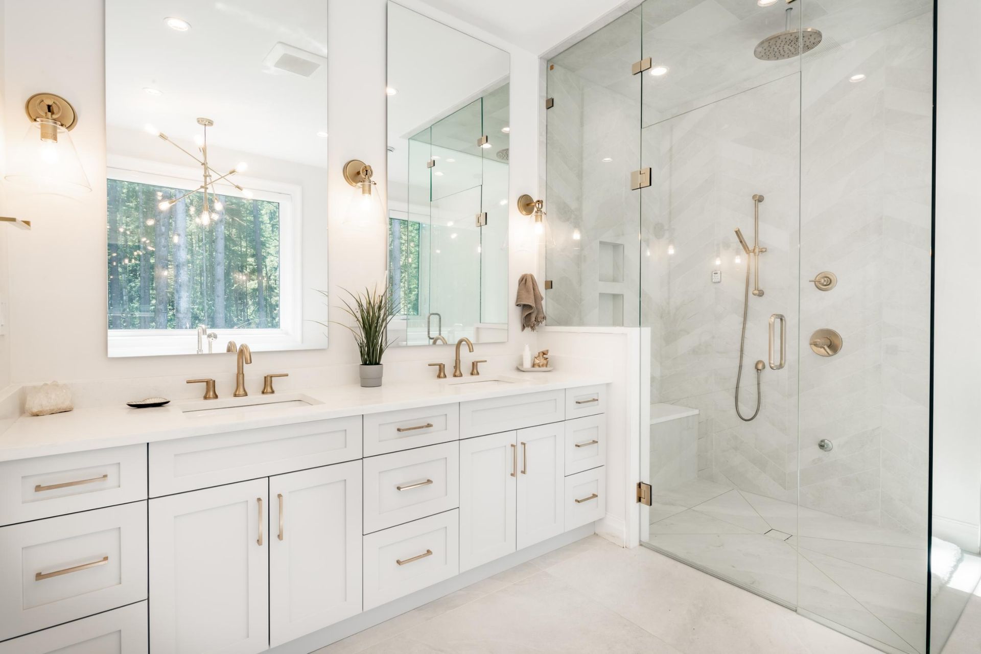 A bathroom with two sinks and a walk in shower.