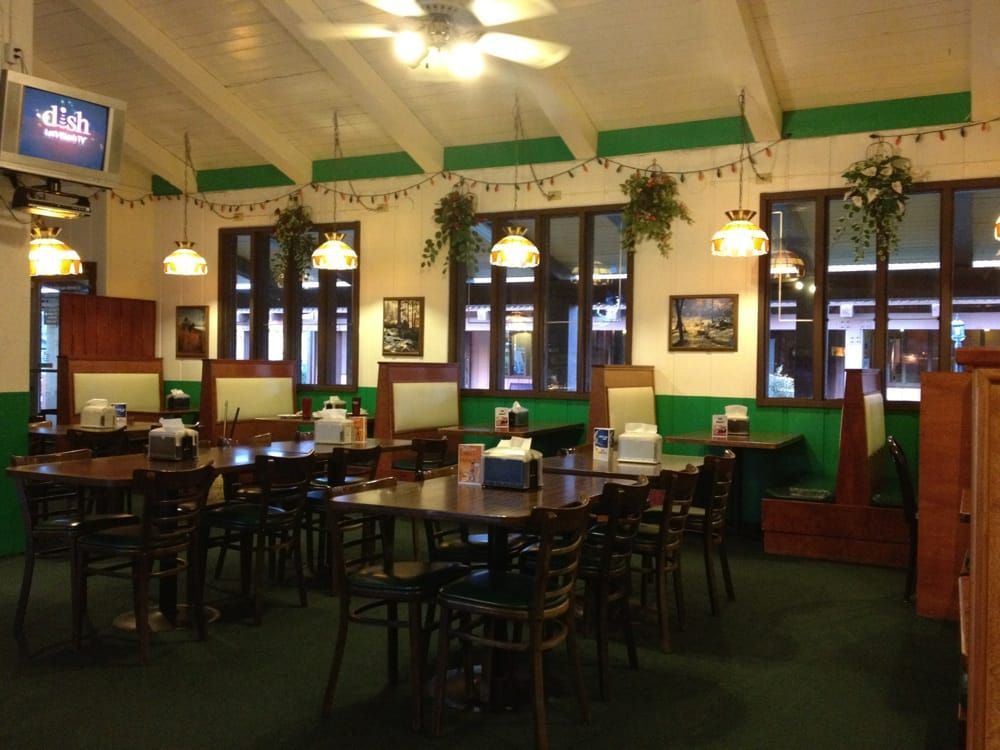 the inside of a restaurant with tables and chairs
