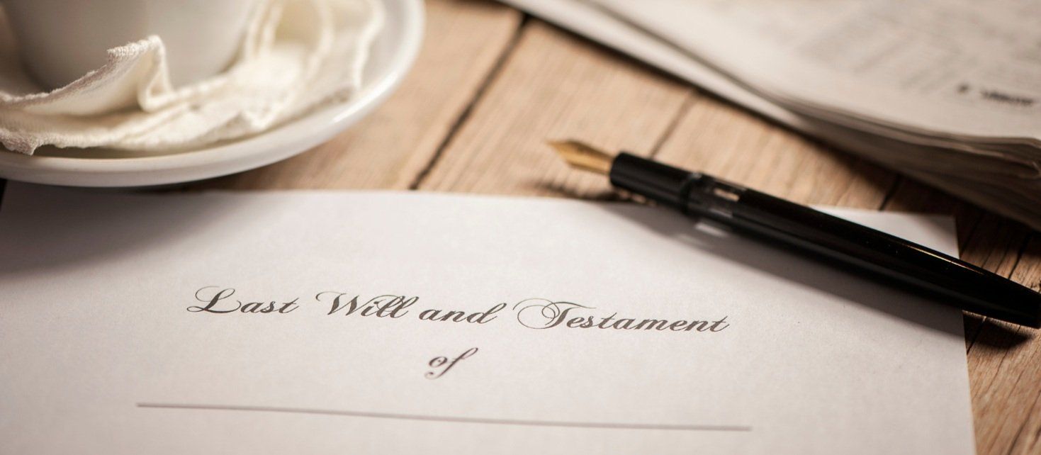 A pen is sitting on top of a piece of paper on a wooden table.