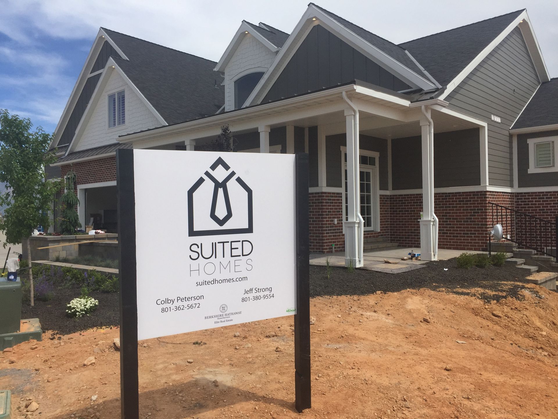 A suter homes sign in front of a house
