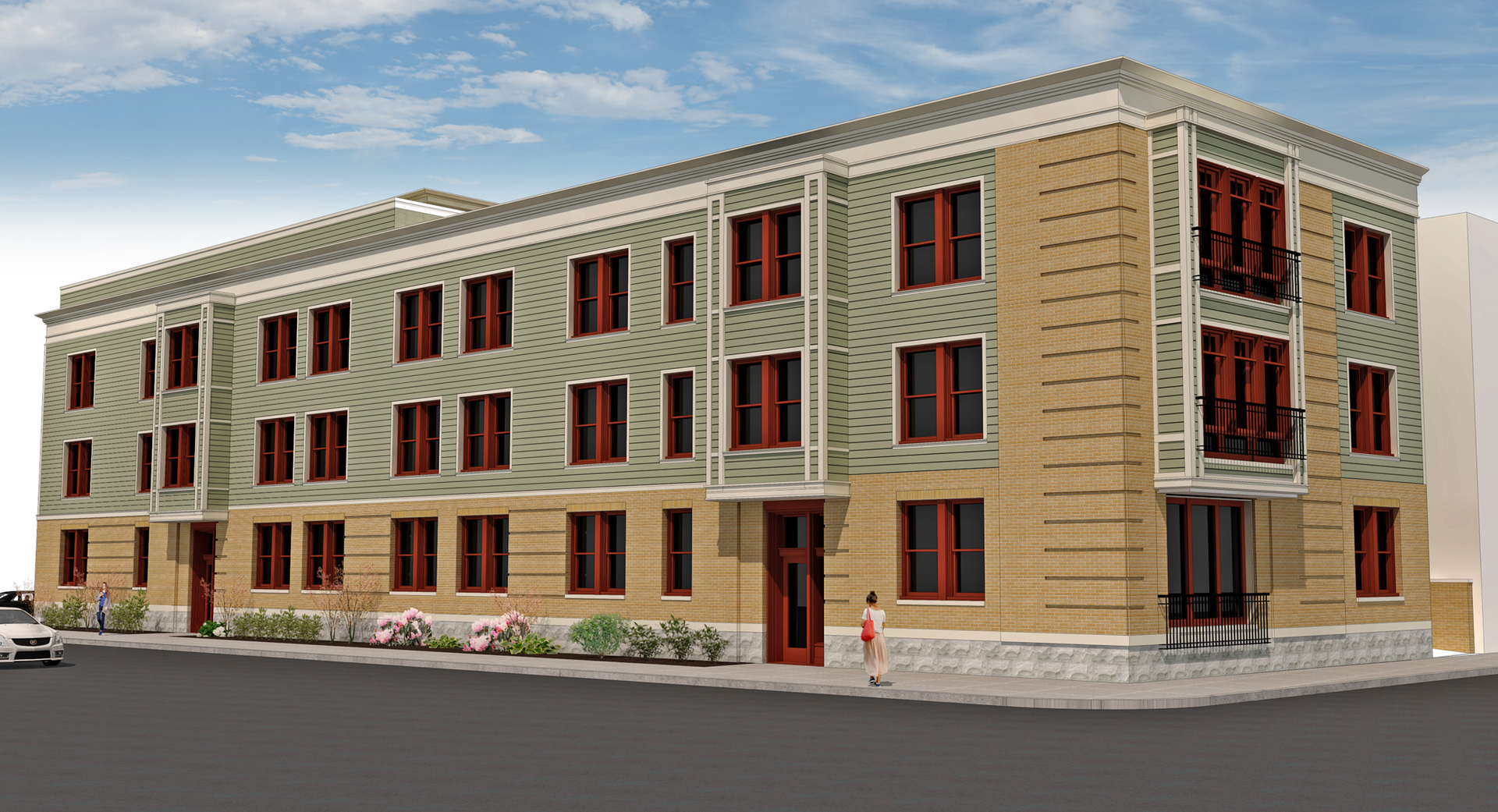 Three-story tan brick apartment building with red shutters on a street corner under a blue sky