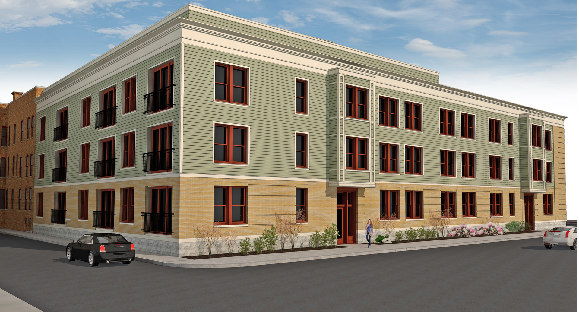 Three-story beige apartment building with red-trimmed windows on a street corner, with parked cars nearby