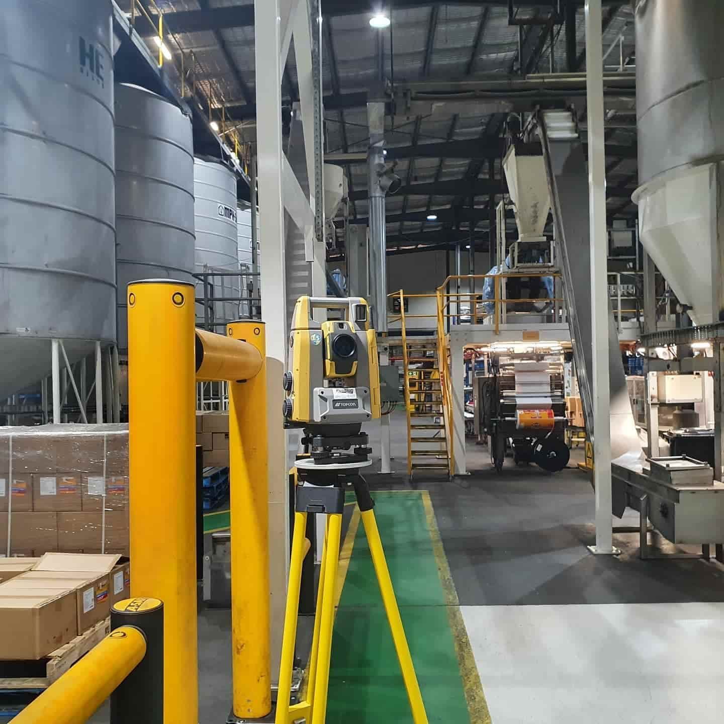 A Yellow Tripod Is In The Middle Of A Factory — Western Survey Pty Ltd In Coonamble, NSW