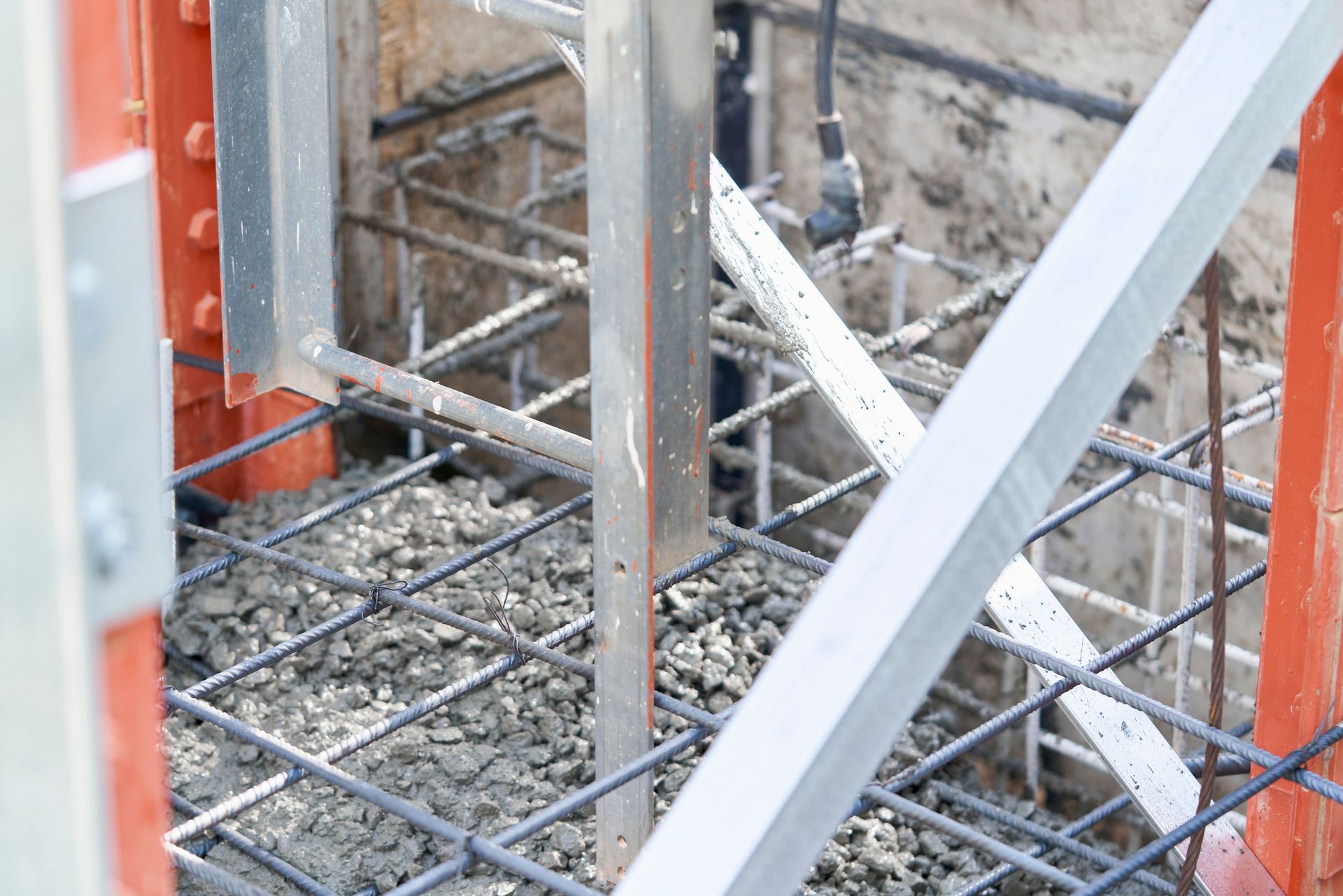 Foundation Metal Beam Bracing with reinforced concrete and steel supports at building site.