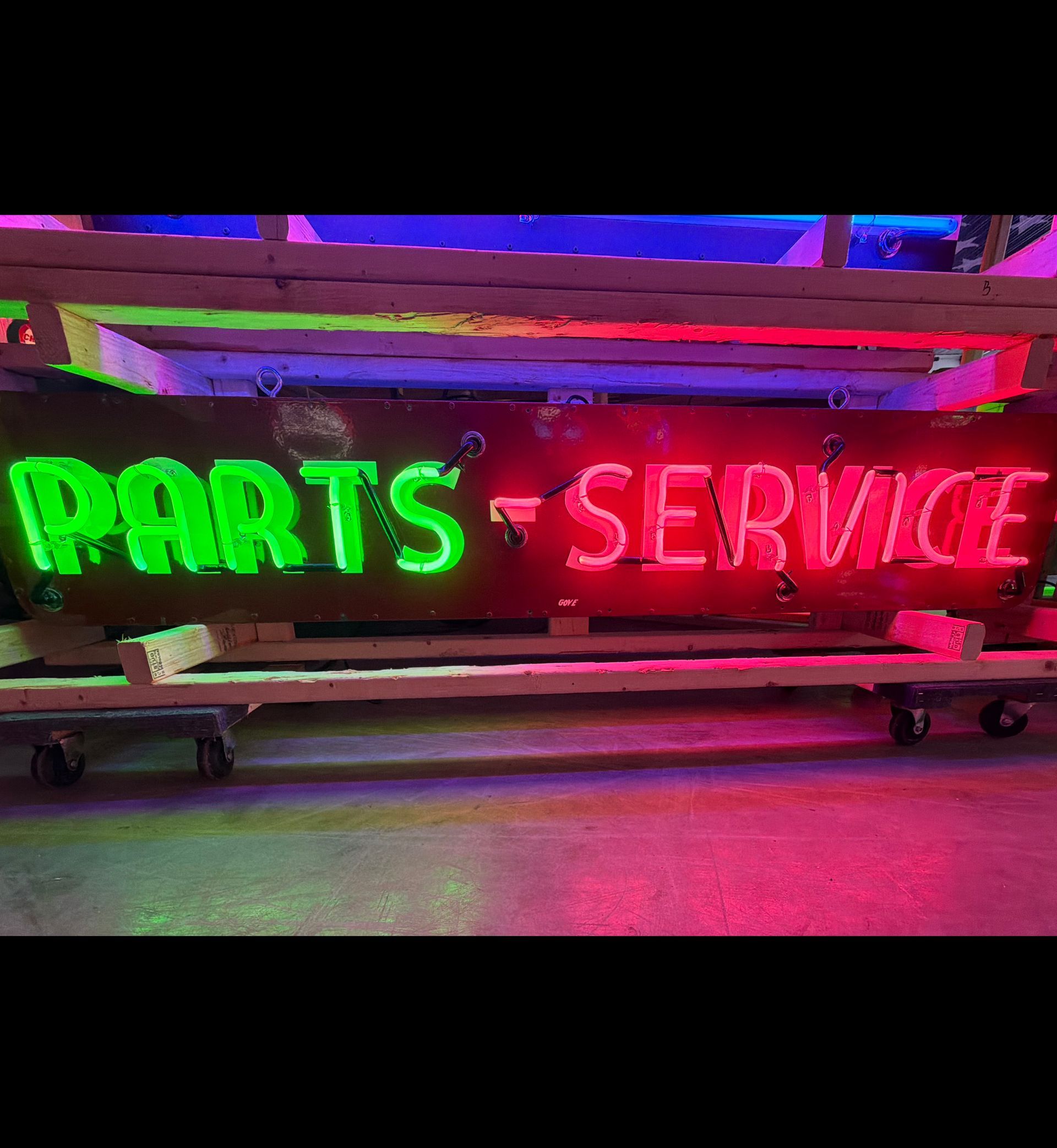 Neon green “PARTS” and red “SERVICE” sign