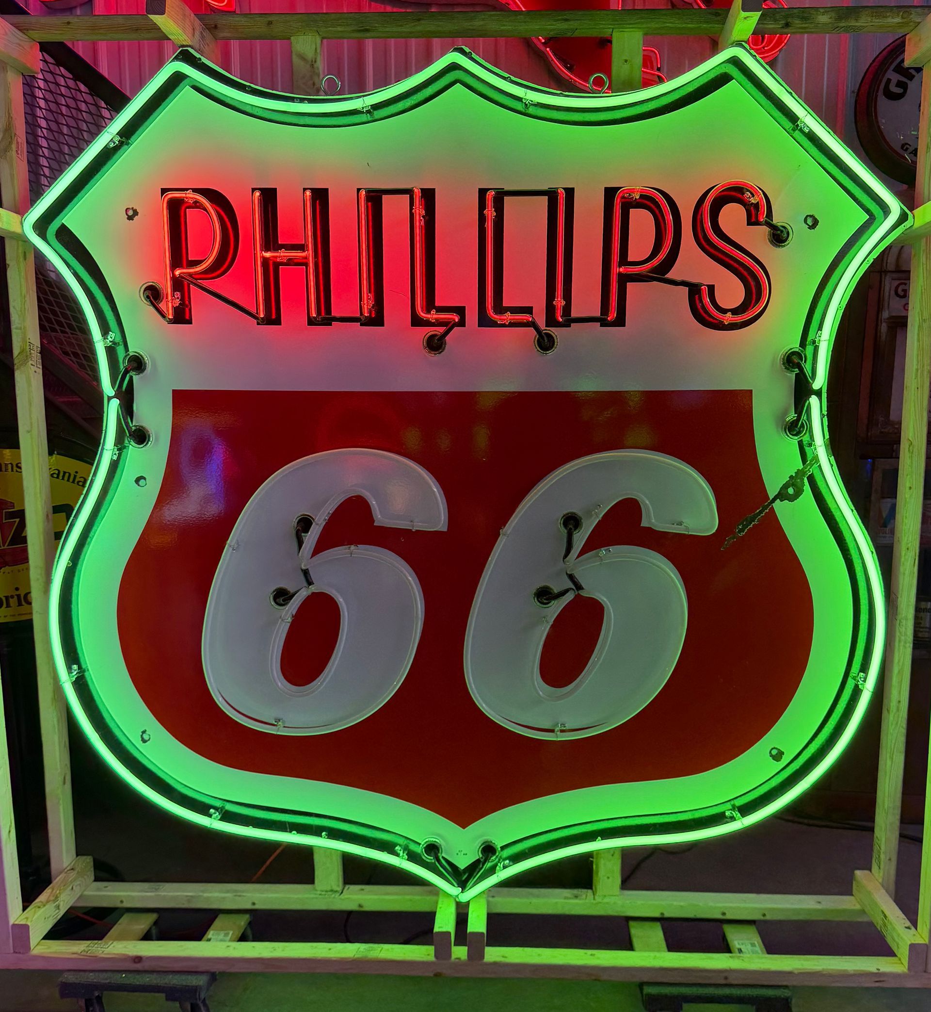Neon Phillips 66 sign with red shield and green outline