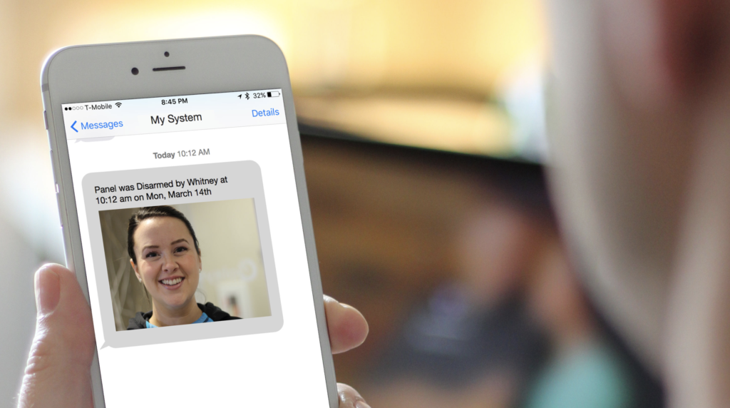 A person is holding a cell phone with a picture of a woman on the screen.