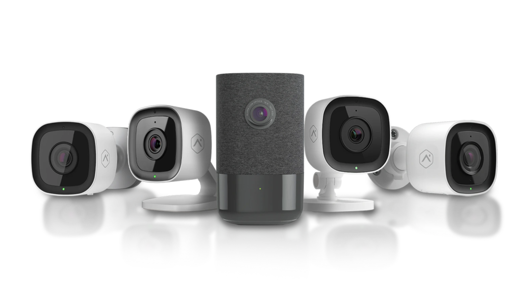 A group of security cameras sitting next to each other on a white surface.