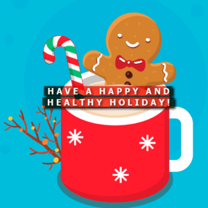 A gingerbread man sits in a cup of hot chocolate with a candy cane