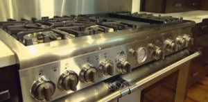 A stainless steel stove top oven is sitting in a kitchen.