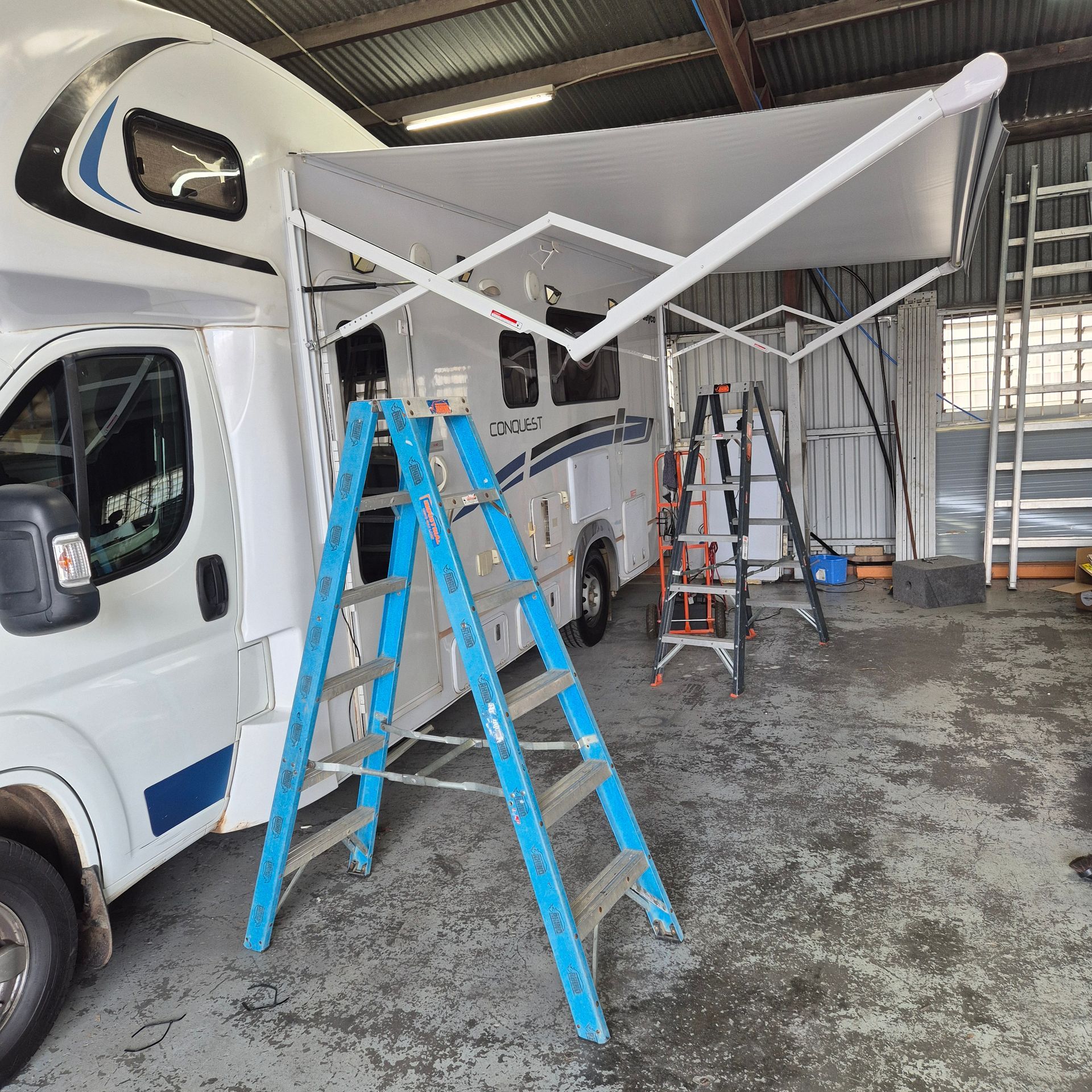 A Caravan with Extended Awning and Ladders — Revive Caravan Repairs in Kippa-Ring, QLD