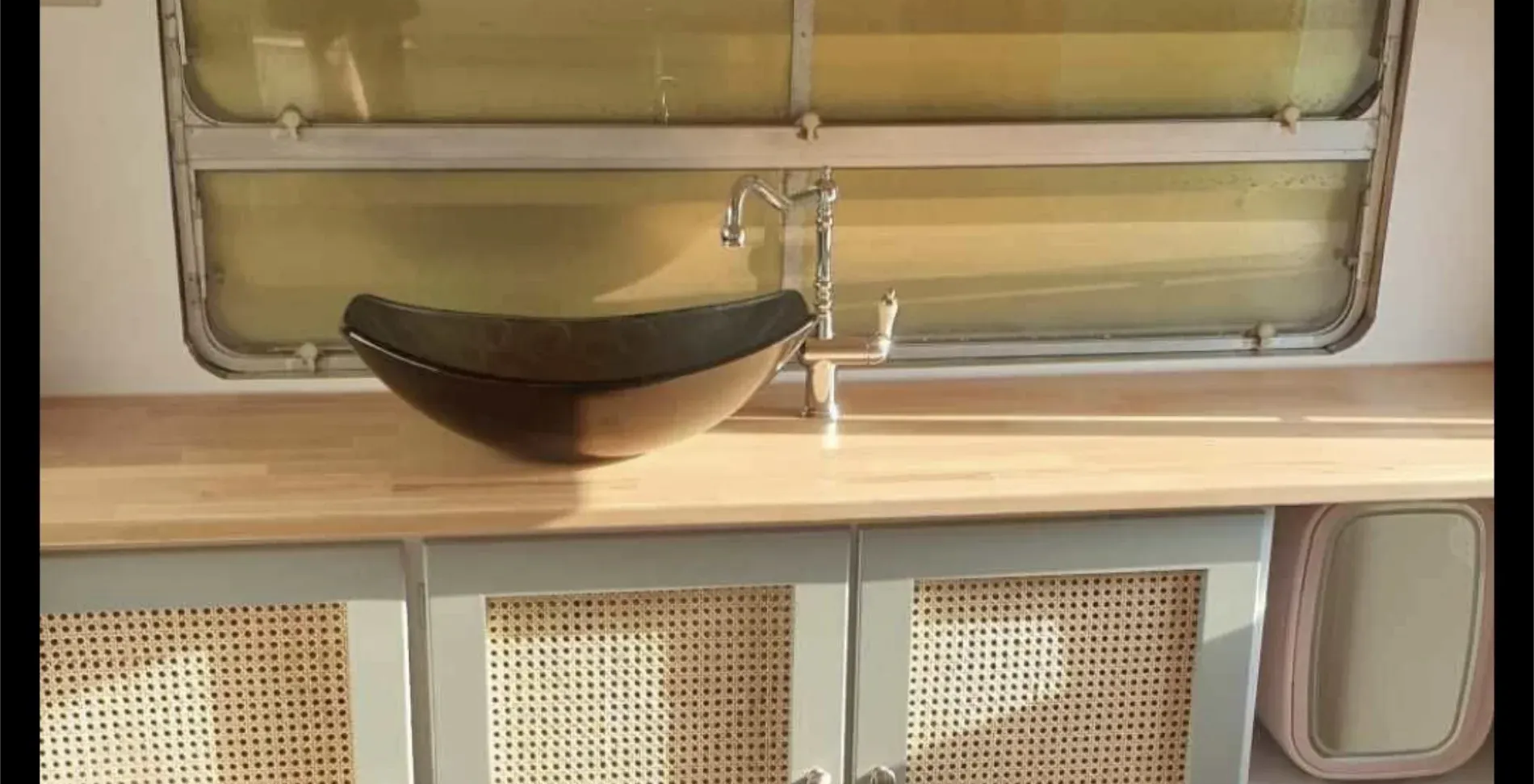 Bathroom with a wooden countertop, bowl sink, and cabinet doors with woven inserts — Revive Caravan Repairs in Kippa-Ring, QLD