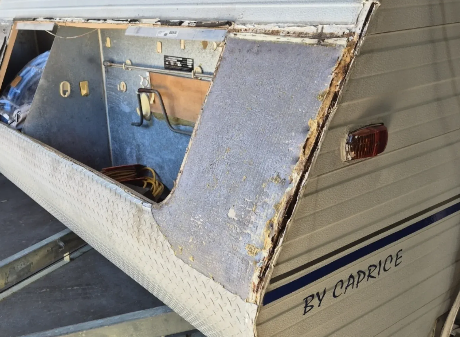 Damaged RV corner with exposed insulation and