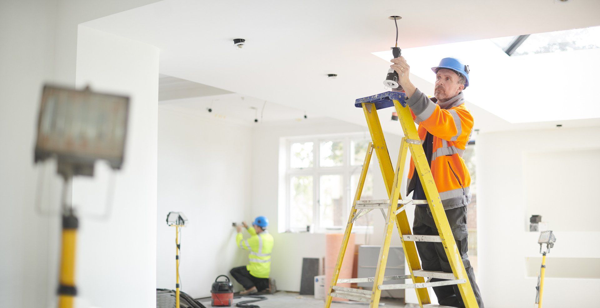 Electrician Installing Downlights - Shreveport, LA - HMR Electrical Contracting LLC