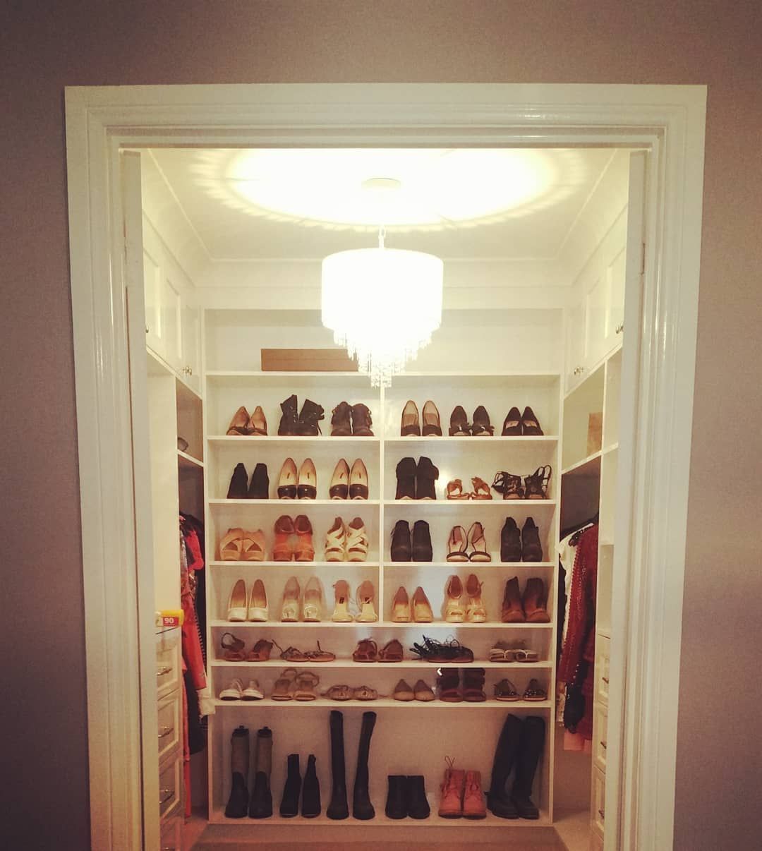 A Closet With Good Lighting Filled With Lots Of Shoes And Boots — Electrician In Wagga Wagga, NSW