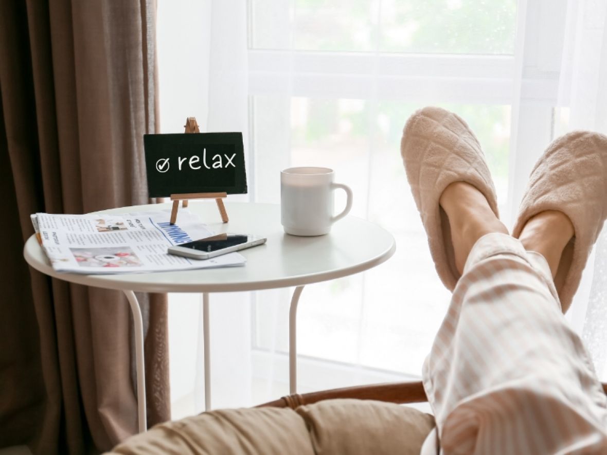 A Person is Sitting in a Chair With Their Feet Up on a Table — Hyde Burchell Buyers Agents In Canberra, ACT