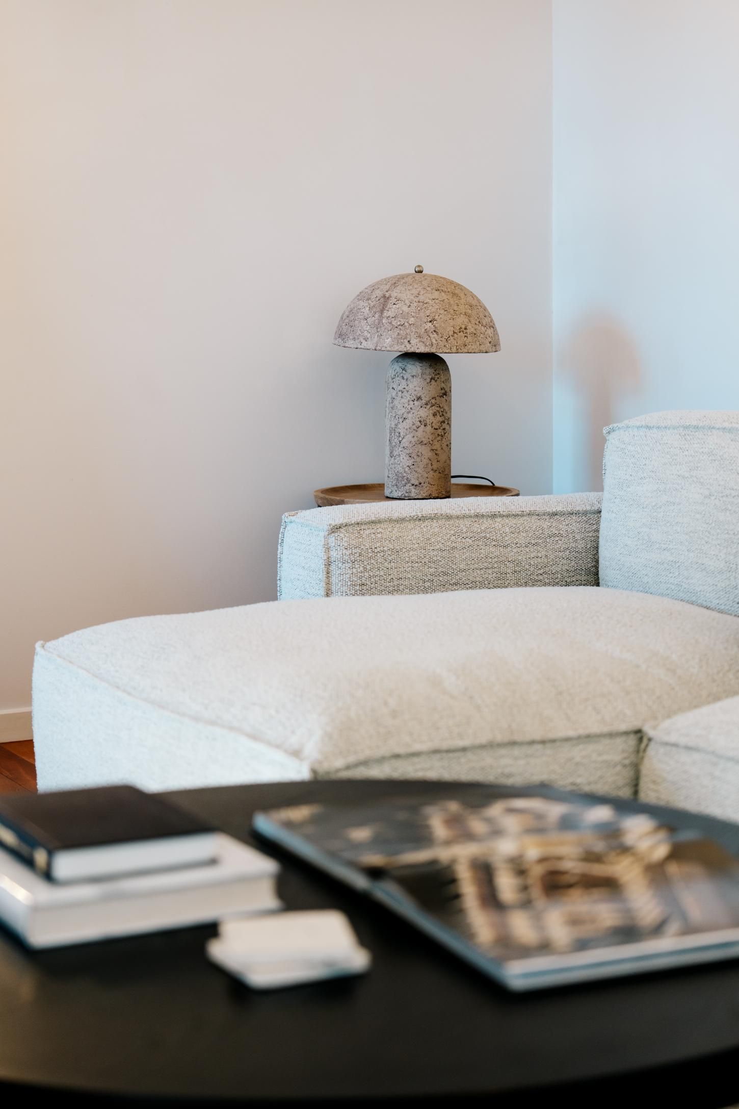 A Modern Living Room Corner With a Textured Lamp on a White Sofa. — Hyde Burchell Buyers Agents