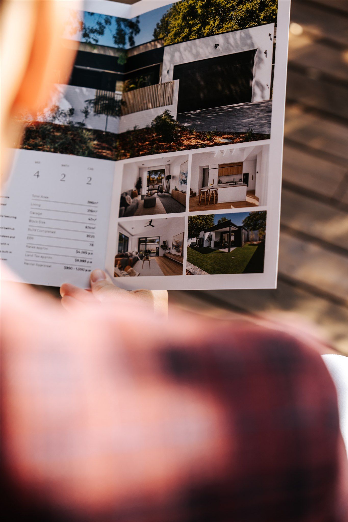 A Close-Up of a Man Reading a Brochure — Hyde Burchell Buyers Agents In Canberra, ACT