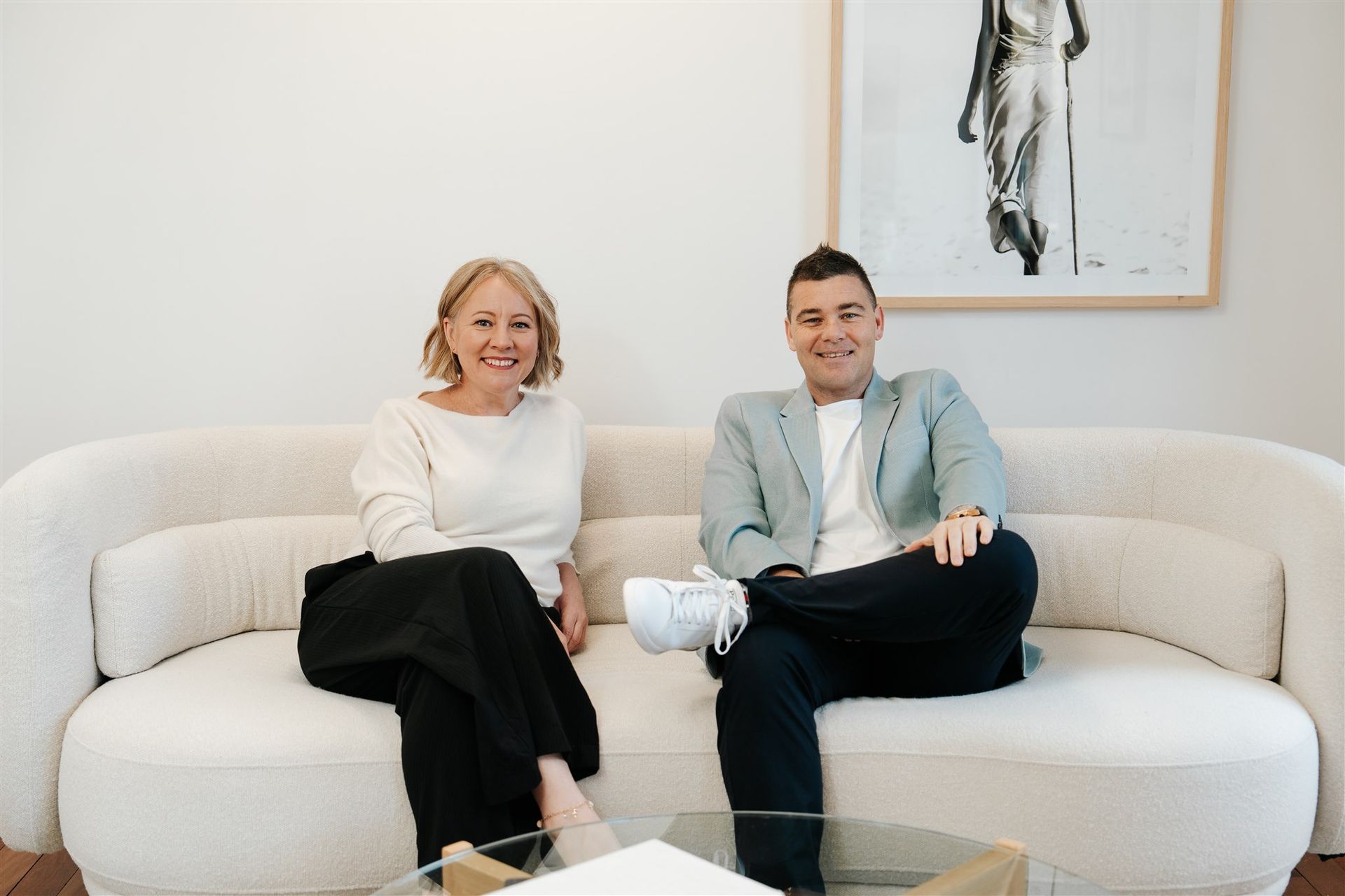 A Man and a Woman Are Sitting at a Table and Smiling  — Hyde Burchell Buyers Agents In Canberra, ACT