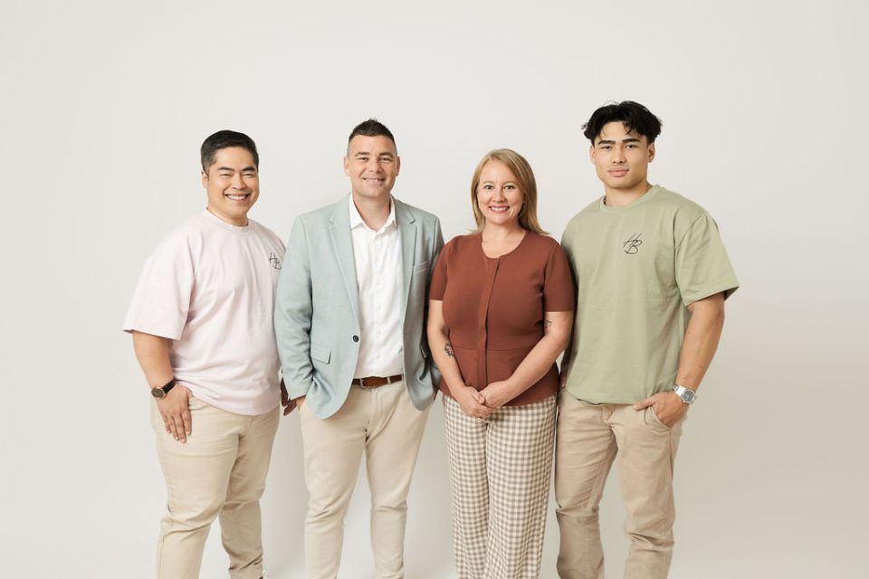 Four People Standing Together Against a Light Background — Hyde Burchell Buyers Agents In Canberra, ACT
