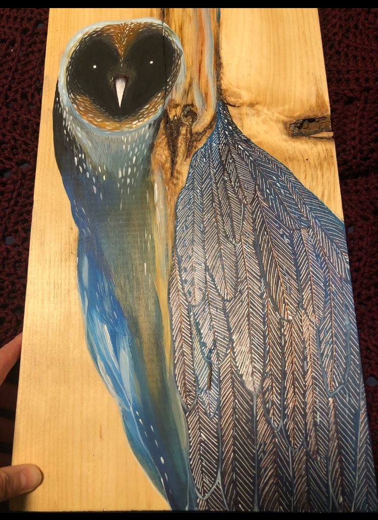 Painting of an owl with a face as dark as the night sky and a body of blue feathers and wood grain melting into that body from above.