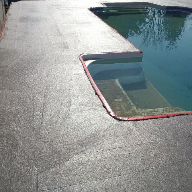 two construction workers are working on a concrete floor