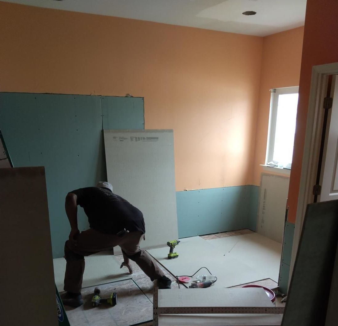 a room under construction with a ladder and buckets