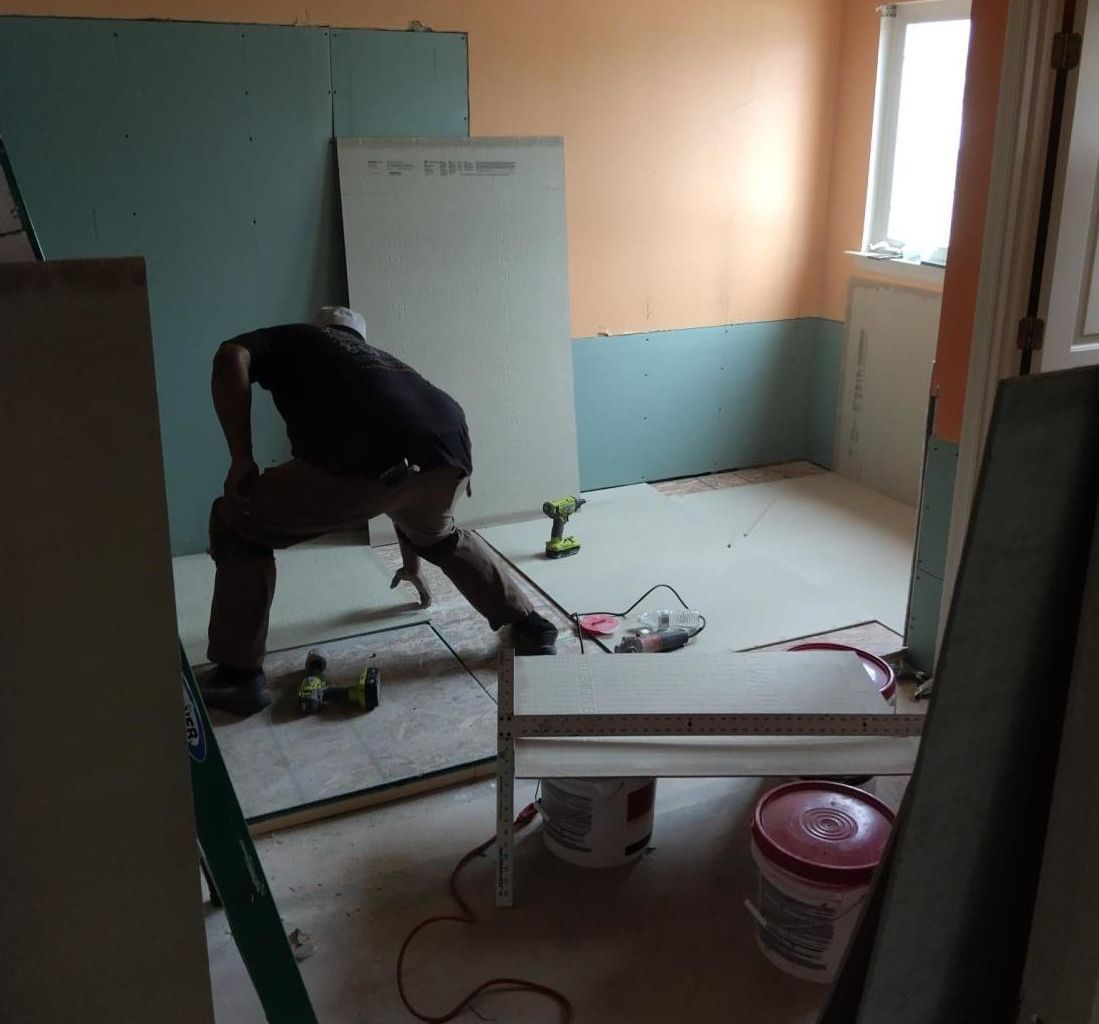 a man is measuring a wall with a tape measure