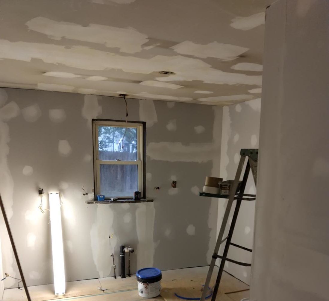 a man is working on a ceiling with a drill