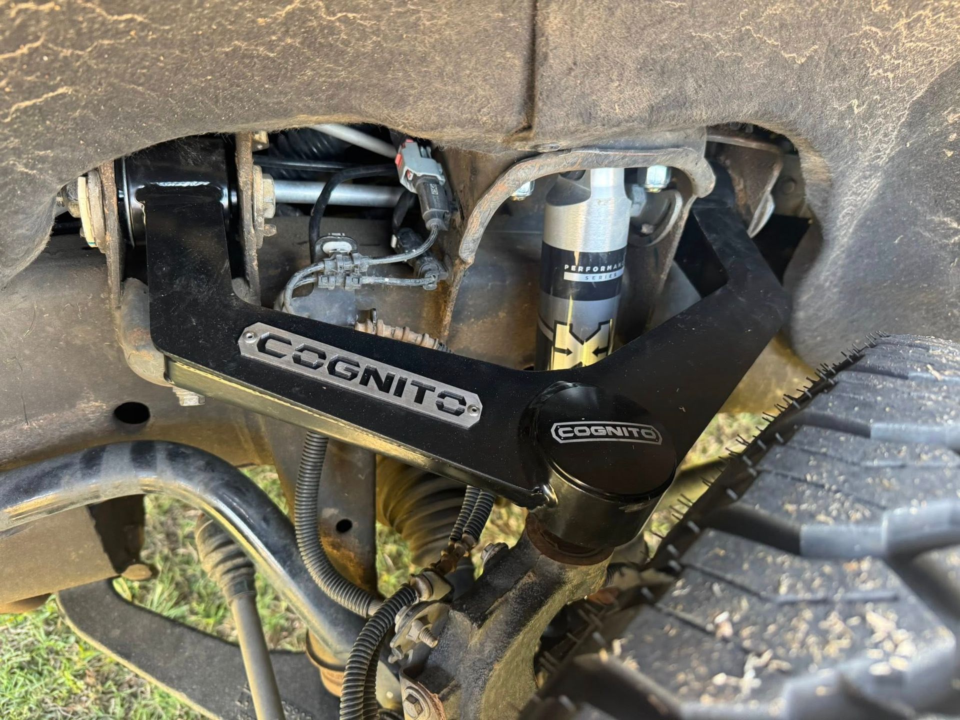Cognit shock absorber and suspension components beneath a dirty off-road vehicle undercarriage