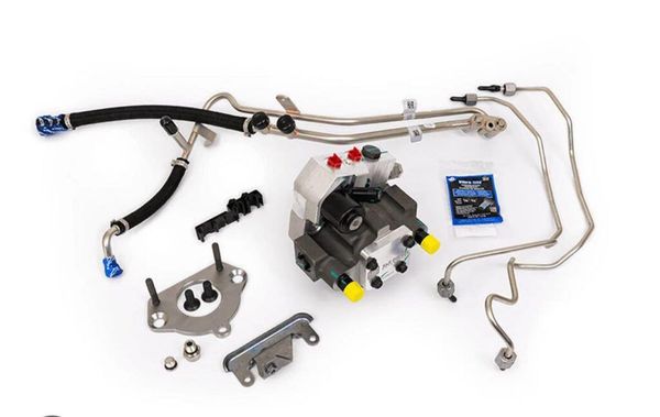 White automotive hydraulic brake line kit with caliper, fittings, and bent metal tubes on a white background
