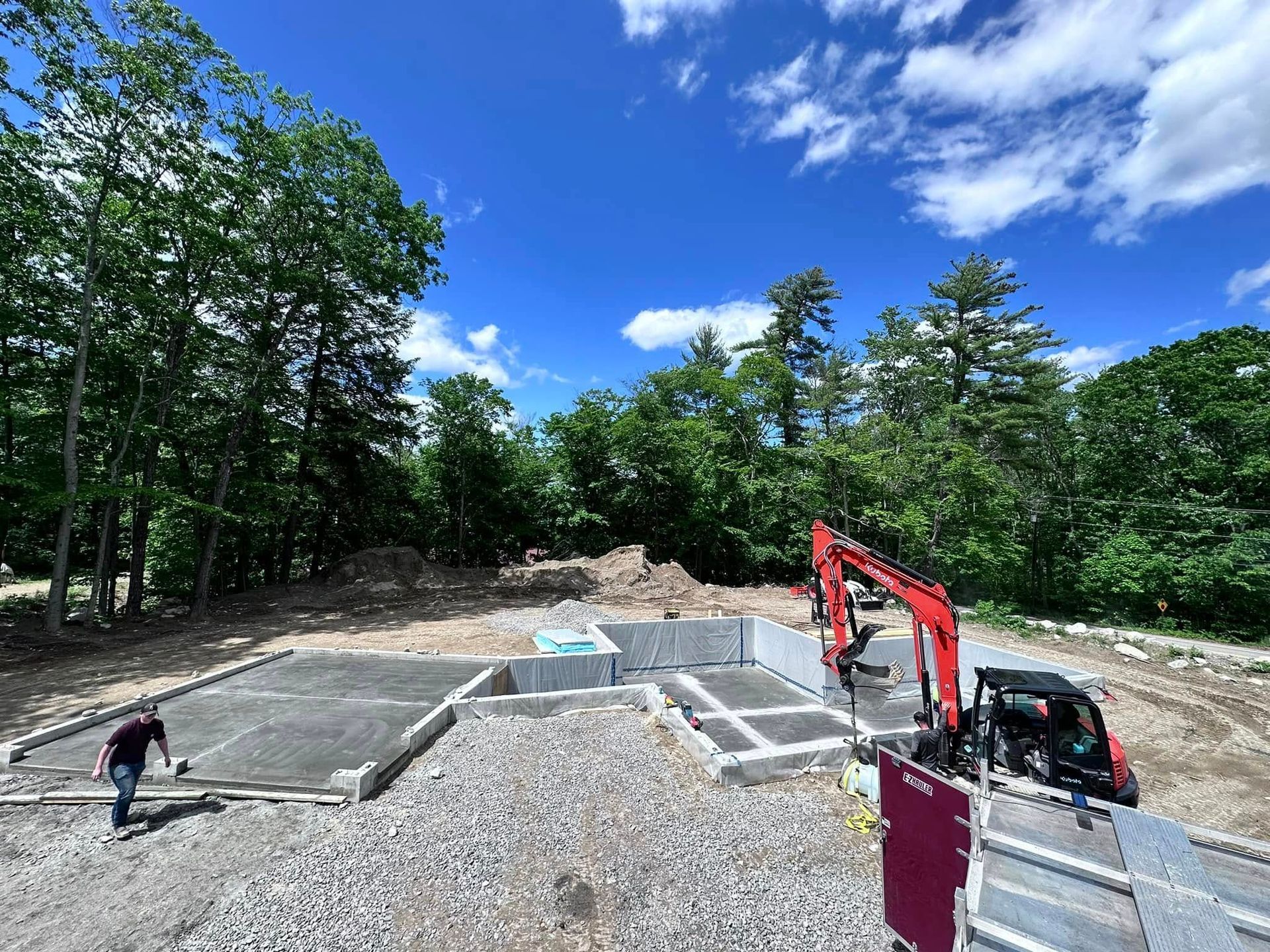 A construction site with a man standing in the middle of it.