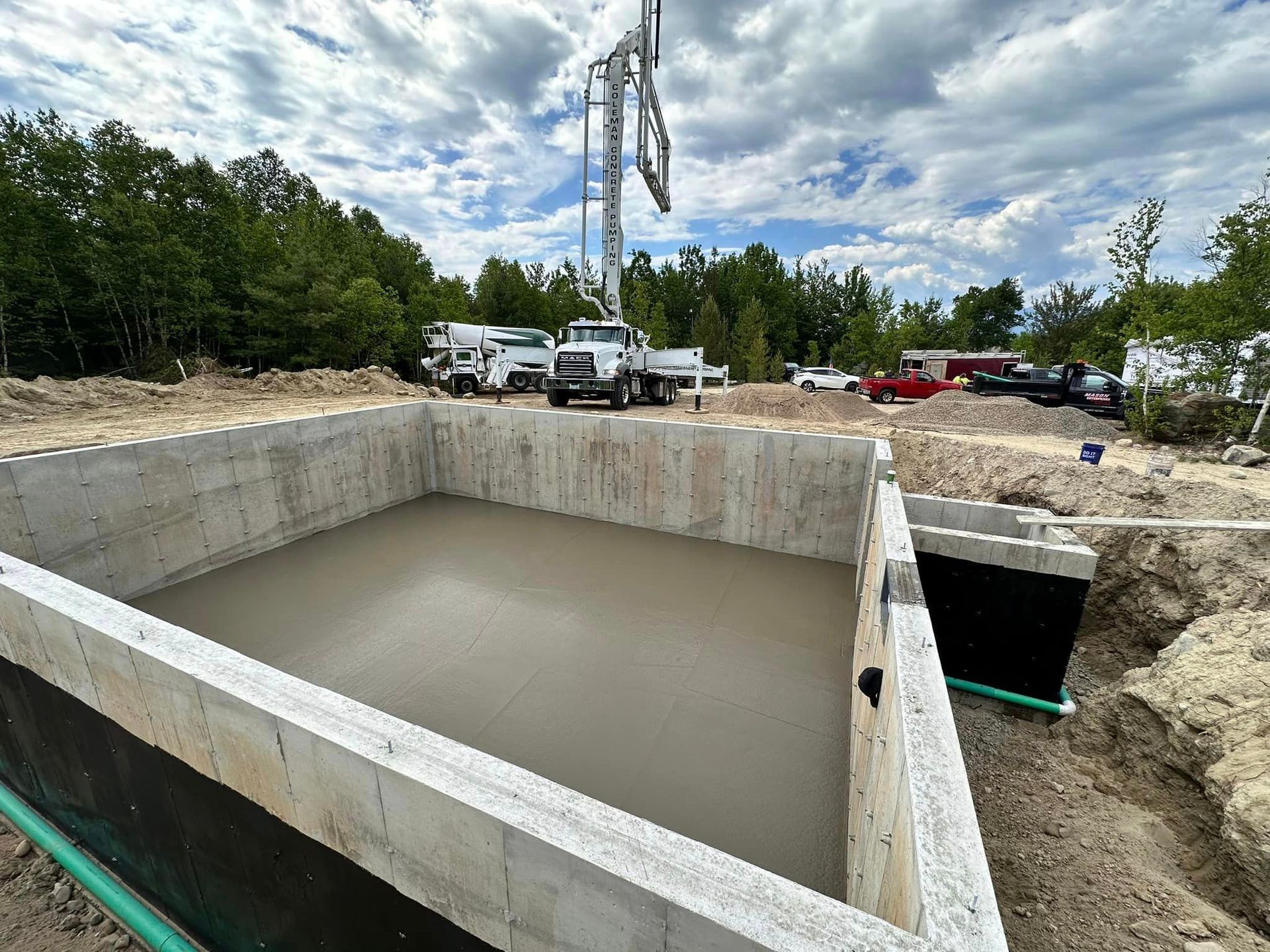 A large concrete foundation is being built in a construction site.