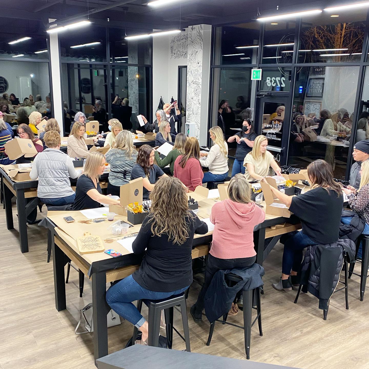 A group of people are sitting at tables in a room.