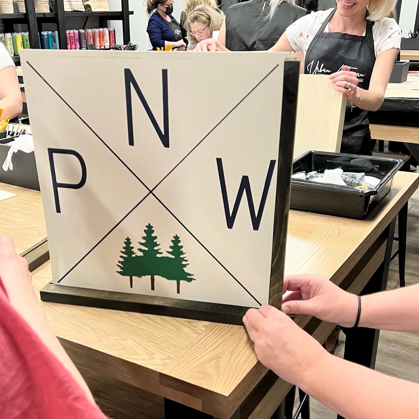 A person is holding a sign with the letters n and p on it.