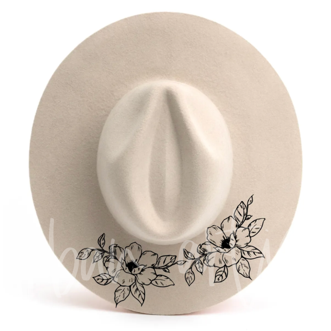 A white hat with black flowers on it
