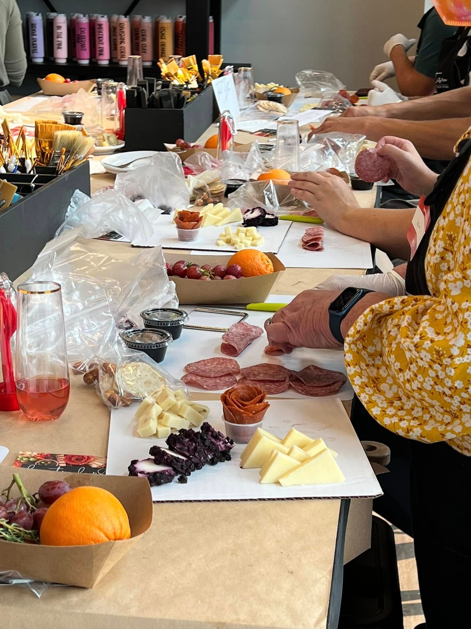 A group of people are sitting at a table with plates of food on it.