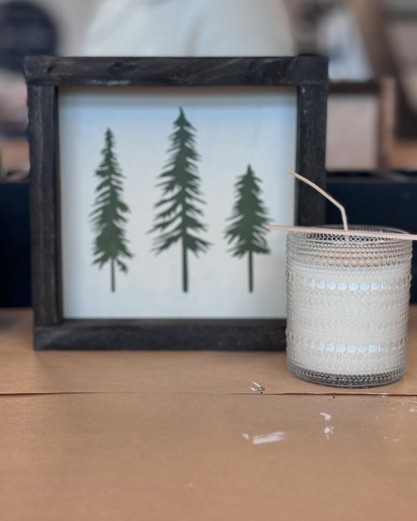 A picture of three trees next to a candle