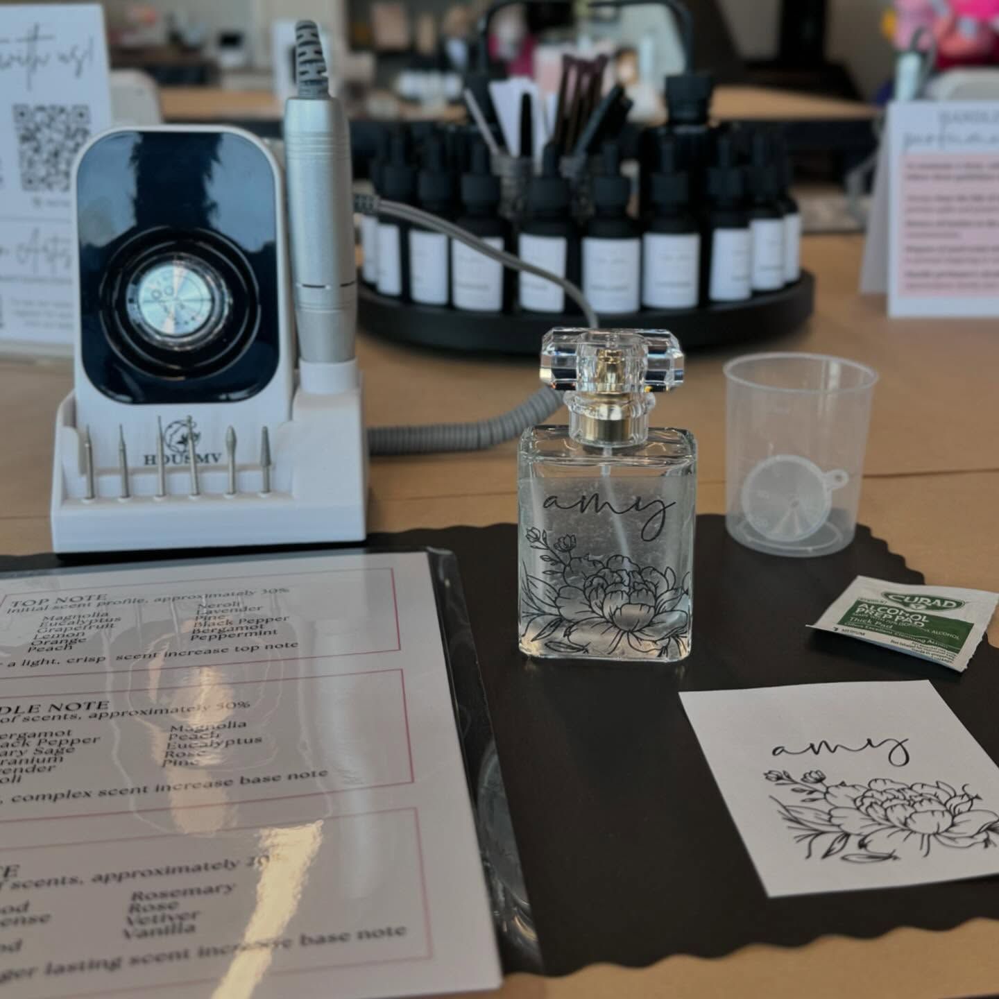 A bottle of amy perfume sits on a table