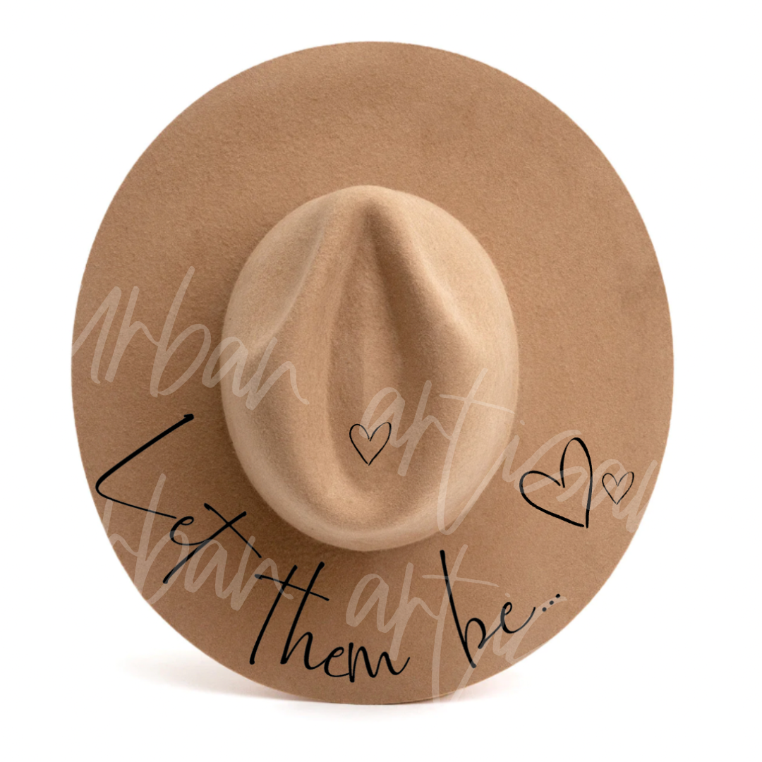 A hat with the words let them be written on it