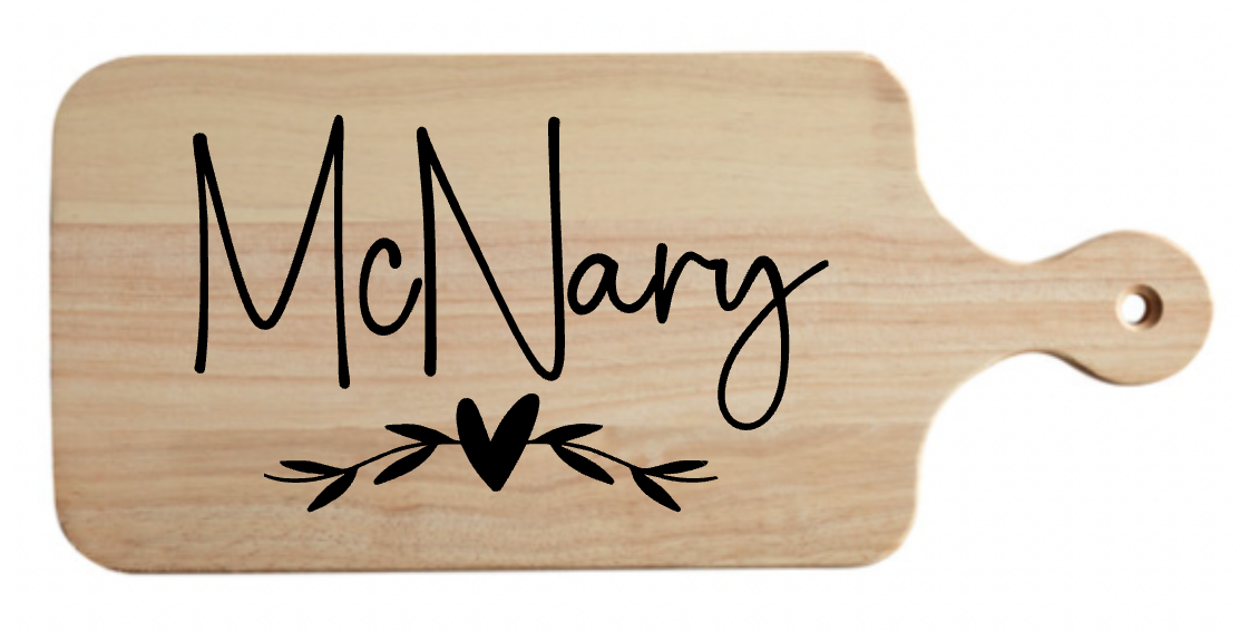 A wooden cutting board with the name mcnary on it