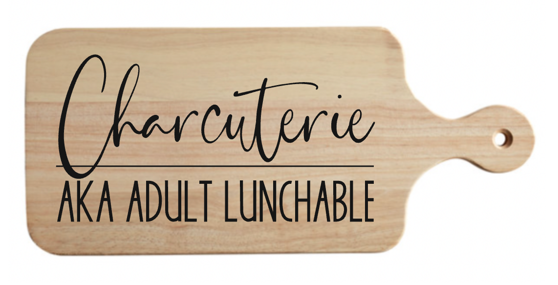 A wooden cutting board that says charcuterie aka adult lunchable