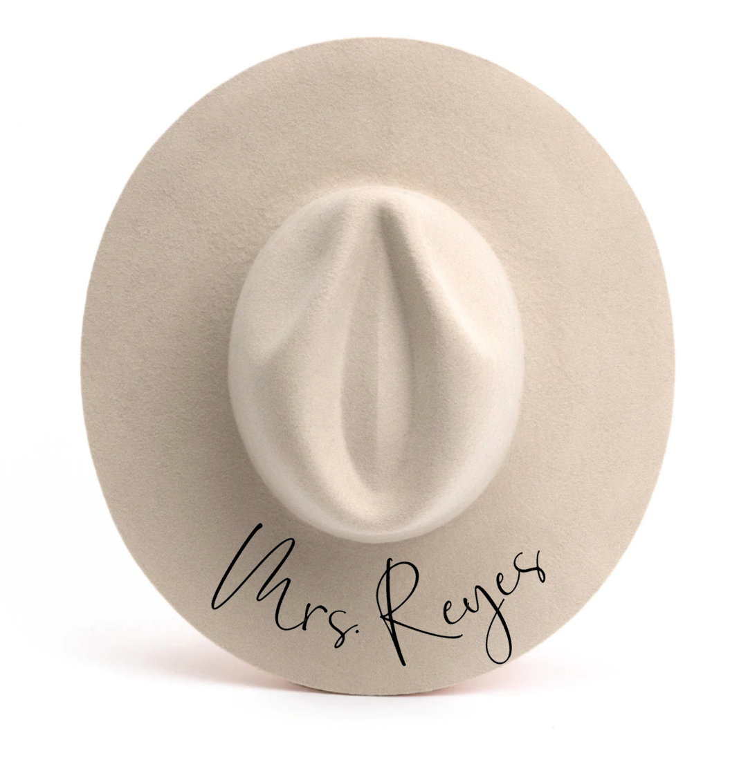 A white hat with the name mrs. reyes written on it