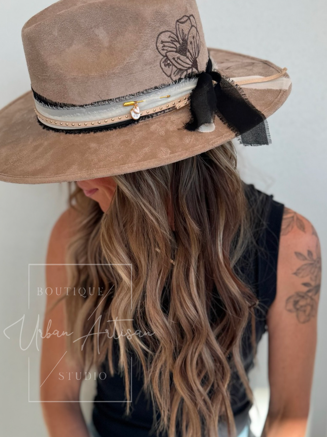 A woman wearing a hat with feathers on it